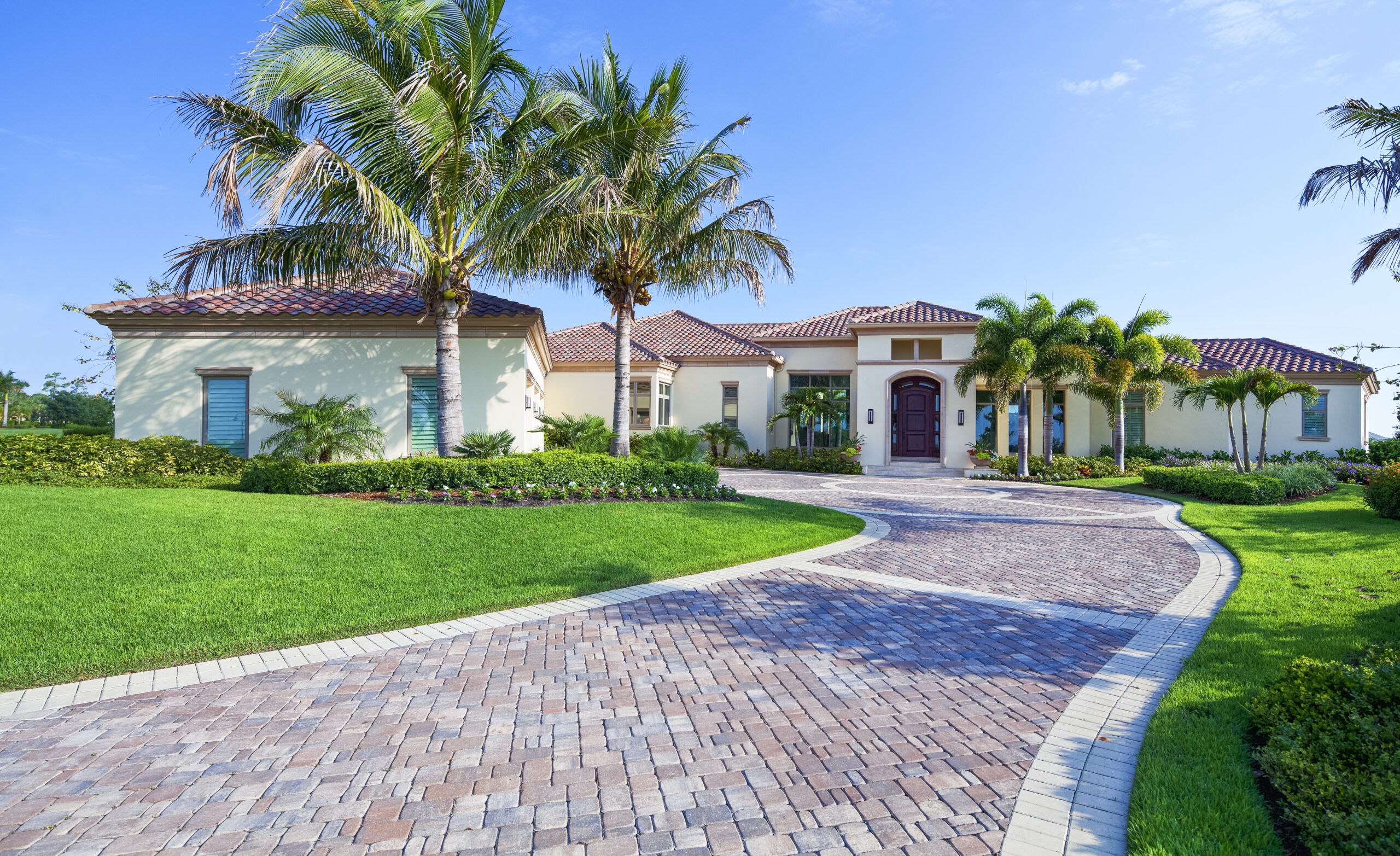 Healthy South Florida St. Augustine lawn with a fertilizer spreader on a sunny day